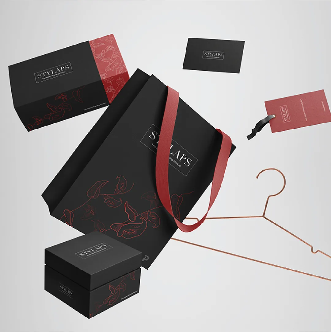 Black and red apparel packaging: boxes, a carry bag, tags and cards on a hanger